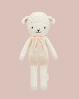 A neutral knit lamb stuffed toy.