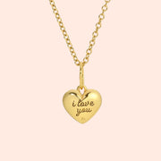 A gold heart shaped pendant necklace with 'i love you' engraved on the back.