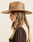 A neutral brown woven sun hat with a wide brim.