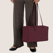 A mahogany colored nylon rectangle handbag with a shoulder bag.