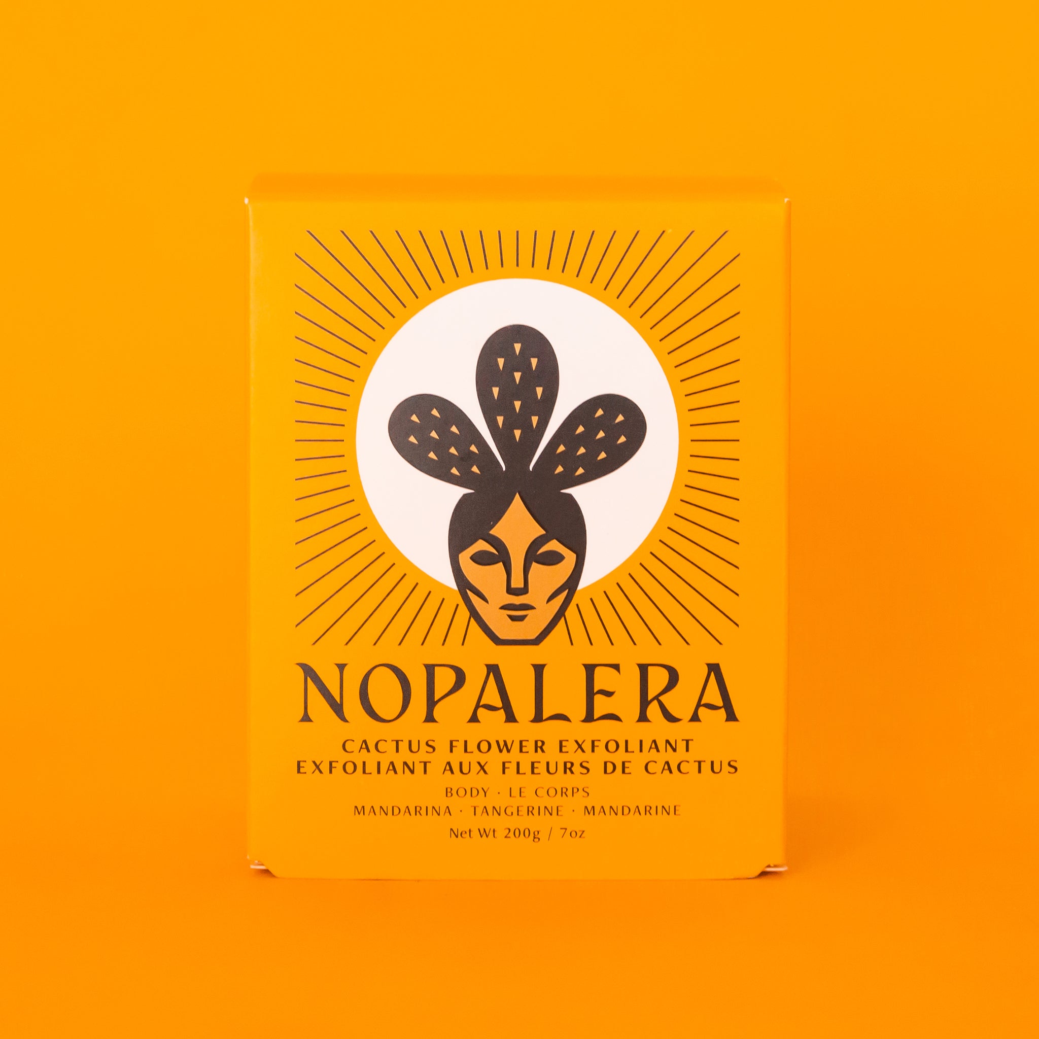 The bright yellow/orange box that the exfoliant comes in with black text on the front that reads, "Nopalera Cactus Flower Exfoliant". 