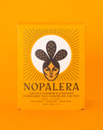 The bright yellow/orange box that the exfoliant comes in with black text on the front that reads, "Nopalera Cactus Flower Exfoliant".