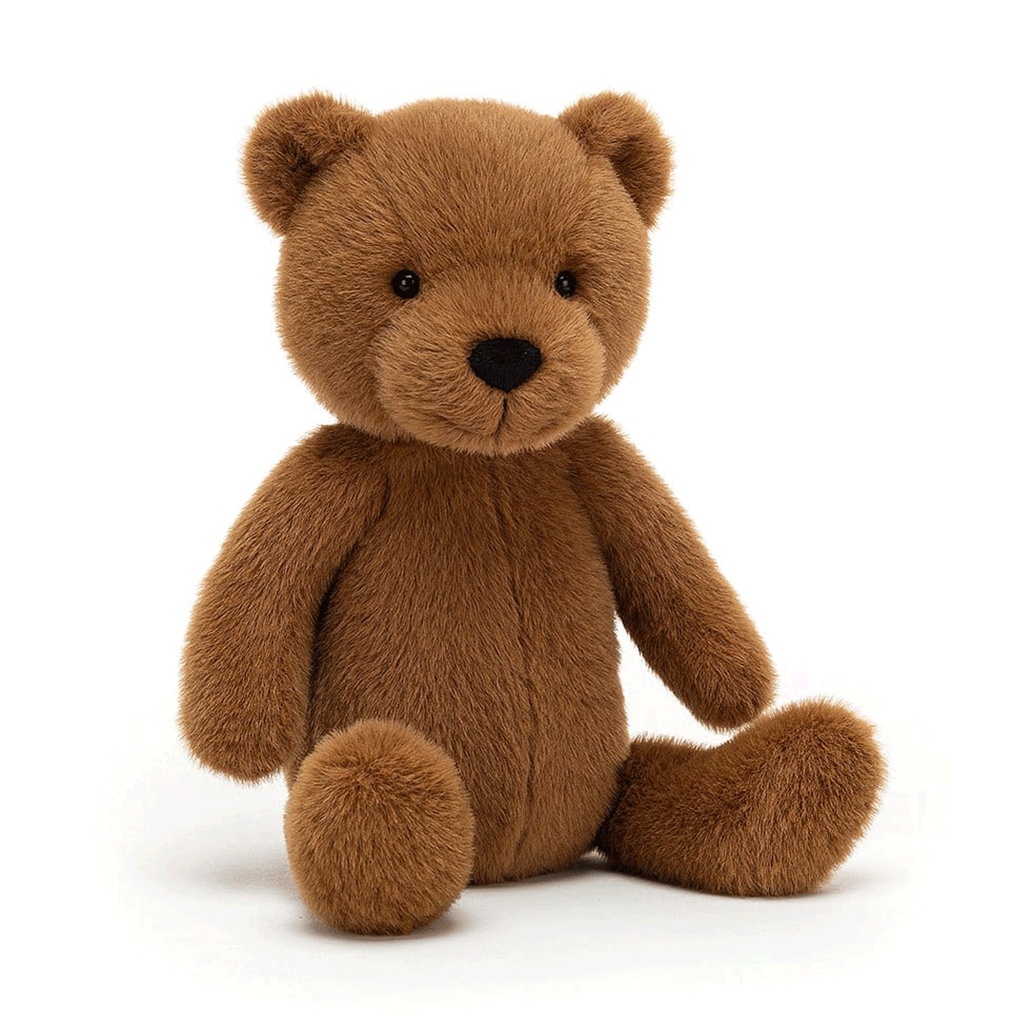 On a white background is a brown stuffed toy bear. 