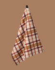 A brown, orange and tan plaid tea towel.