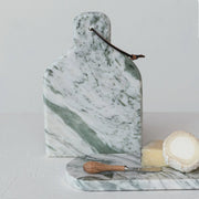 A green marble cutting board with a wood handle knife with stainless steel.