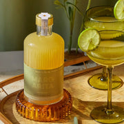 A glass bottle of margarita mix.