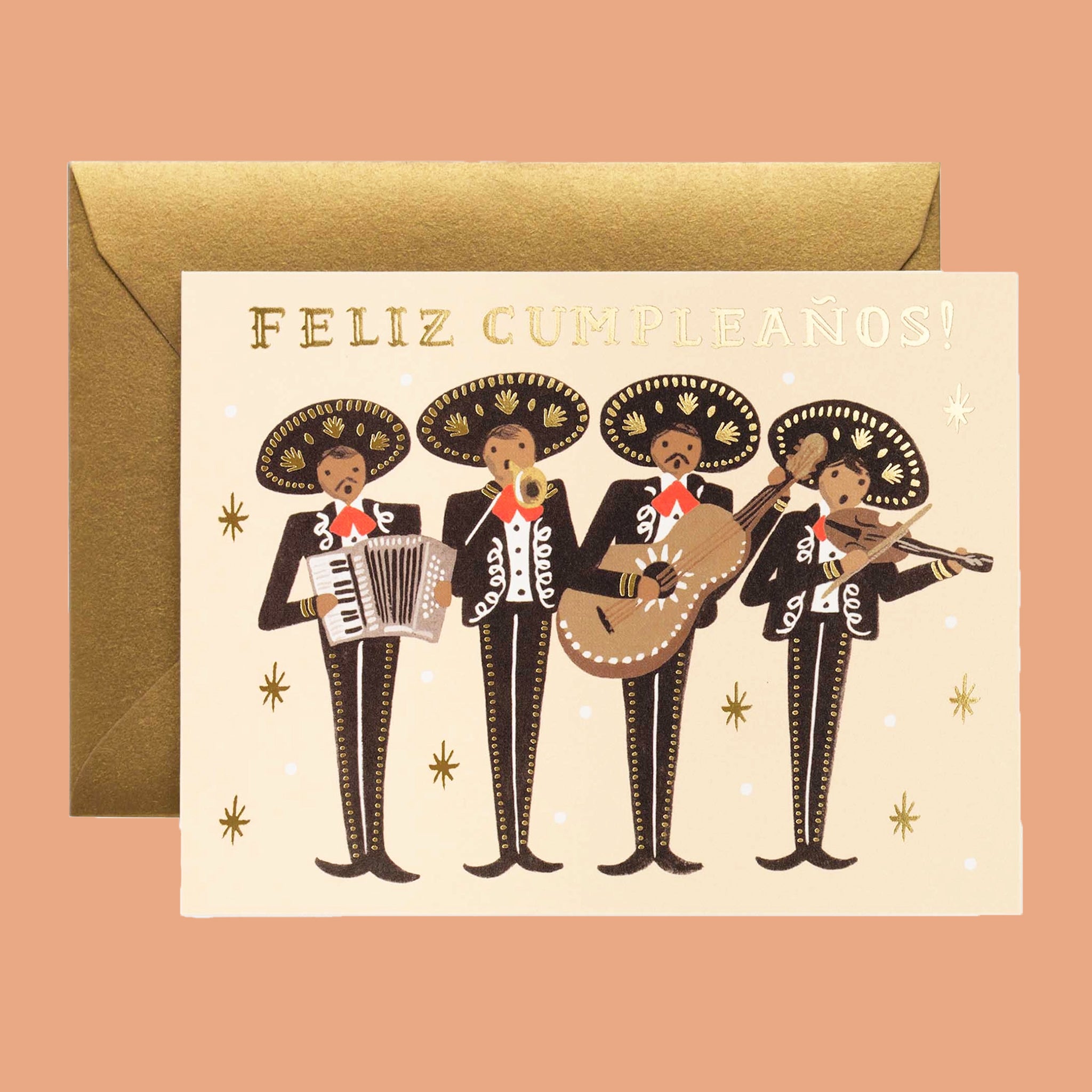 On a cream background is a tan card with a four man mariachi band playing instruments with black suits hats with gold detailing along with gold foiled text at the top that reads, "Feliz Cumpleaños!". It is also accompanies by a gold envelope.