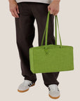 A vibrant green nylon shoulder bag with a zip closure.