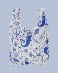 A nylon tote bag with dark blue mermaid themed designs.