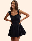 A black mini dress with straps.
