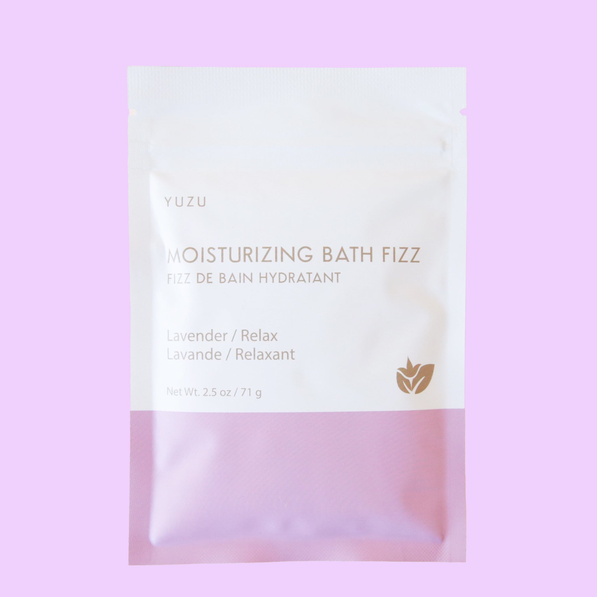 A packet of bath salts with the bottom half a light pink color and the top half white along with text on the front that reads, &quot;Moisturizing Bath Fizz, Lavender / Relax&quot;.