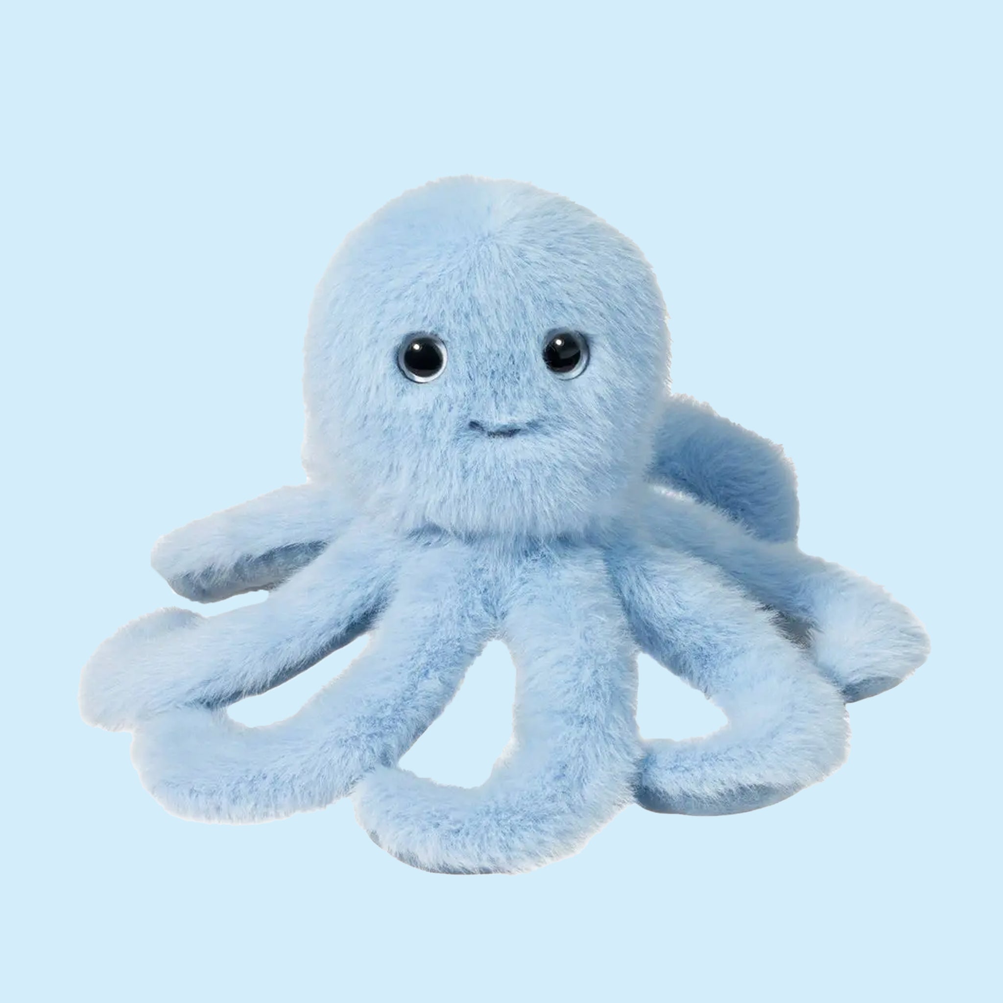 On a blue background is a light blue octopus shaped stuffed toy with a smiling face. 