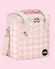 On a light pink background is a pink and white cooler bag with a long adjustable strap.