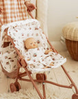 A rosey pink and ivory floral print doll stroller.
