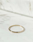 A minimal gold band ring.