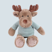 A fuzzy brown moose shaped stuff toy with a blue shirt on.