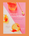 On a pink background is a pink bar book with cocktail glasses on the front cover and a title that reads, "mod cocktails Modern Takes on Classic Recipes from the '40s, '50s and '60s".