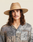 A neutral brown woven sun hat with a wide brim.