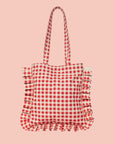 A red and white gingham printed tote bag with shoulder straps and a ruffle edge detail.