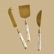 A mother of pearl set of cheese knives.