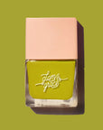 A square bottle of green nail polish.