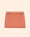 A light pinkish orange vegan leather wallet with a thin removable crossbody strap.