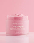 A pink container of sugar body scrub.