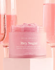 A pink container of sugar body scrub.