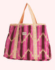 A terry tote bag with pink, burnt orange and yellow chevron design.