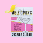 A pink and white packet of craft cocktail mix that says, "Noble Mick's Single Serve Craft Cocktails" along with a martini glass.