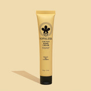 A yellow bottle of hand cream with black details and text that reads, 'Nopalera Cactus Hand Cream'.