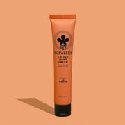 An orange hand cream with black details with text that reads, 'Nopalera Cactus Hand Cream'.