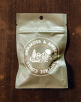 A bag of 20 incense cones in a neutral packaging with text that reads, 'Oakmoss & Amber Incense Cones'.