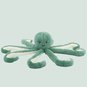 A green octopus shaped stuffed animal toy.