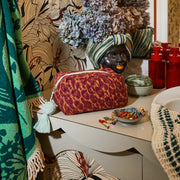 Red and orange quilted makeup bag with a light blue tassel.