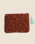 A velvet pouch with an orange and red leopard print.