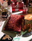 A velvet pouch with an orange and red leopard print.