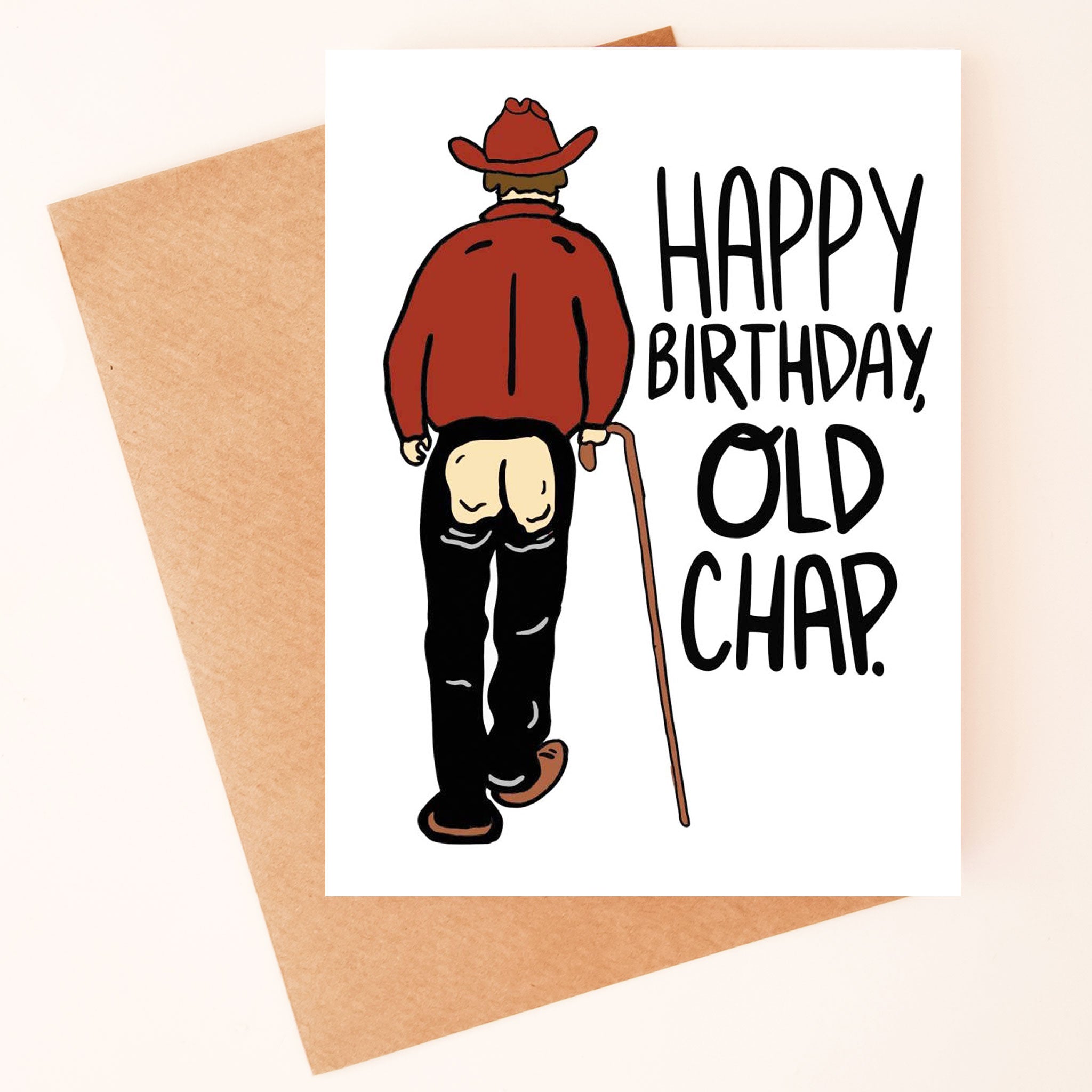 On a neutral background is a white card with an illustration of a cowboy with chaps on and an open bottom area along with black text to the right that reads, "Happy Birthday Old Chap". 