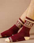 On a neutral is a model wearing a pair of dark red socks with ivory details and text at the top that reads, "Old Fart".