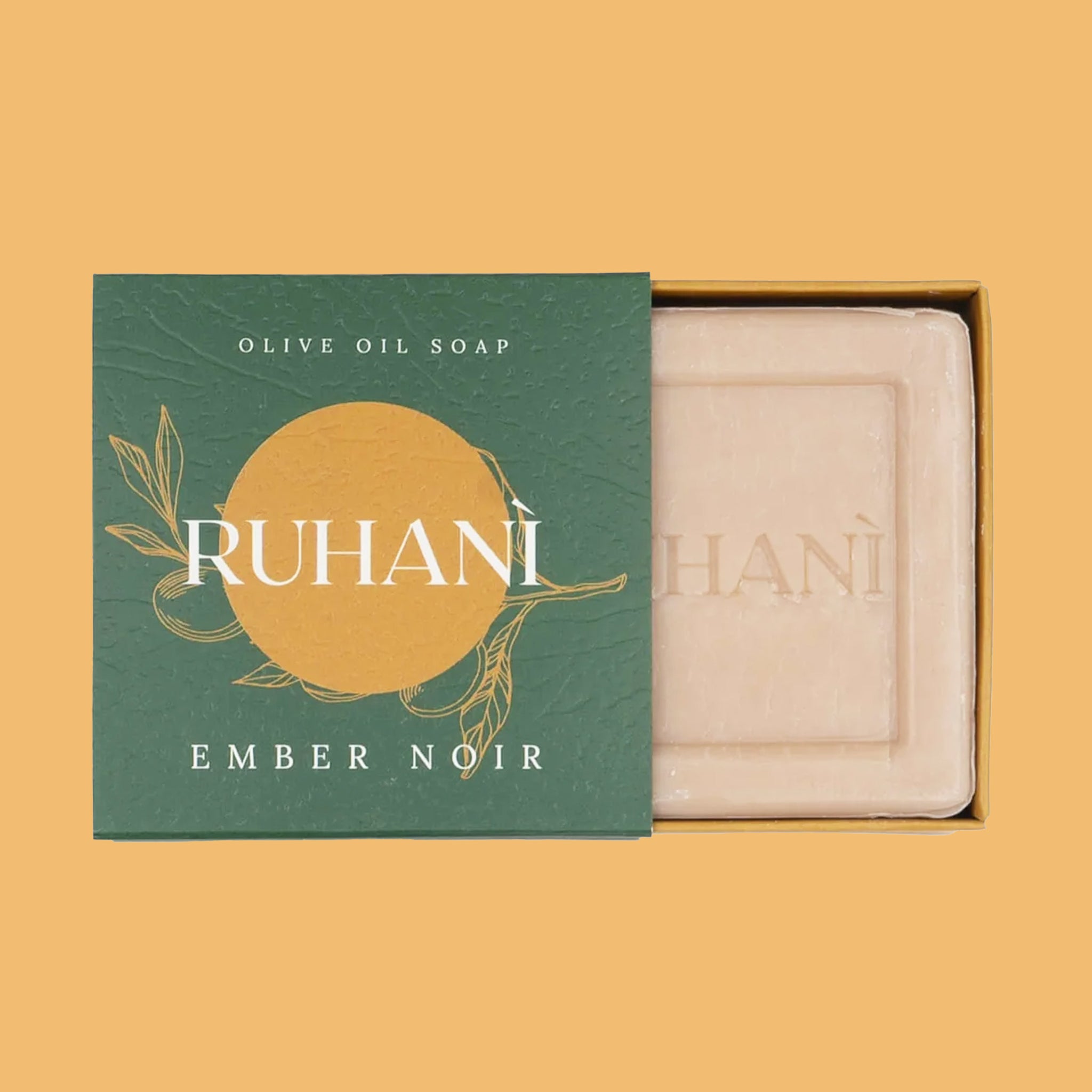 A bar of soap in a green and yellow packaging that reads, &quot;Ruhani Ember Noir&quot;. 