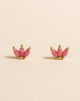 A pair of pink crown shaped stud earrings made of pink opal stones.