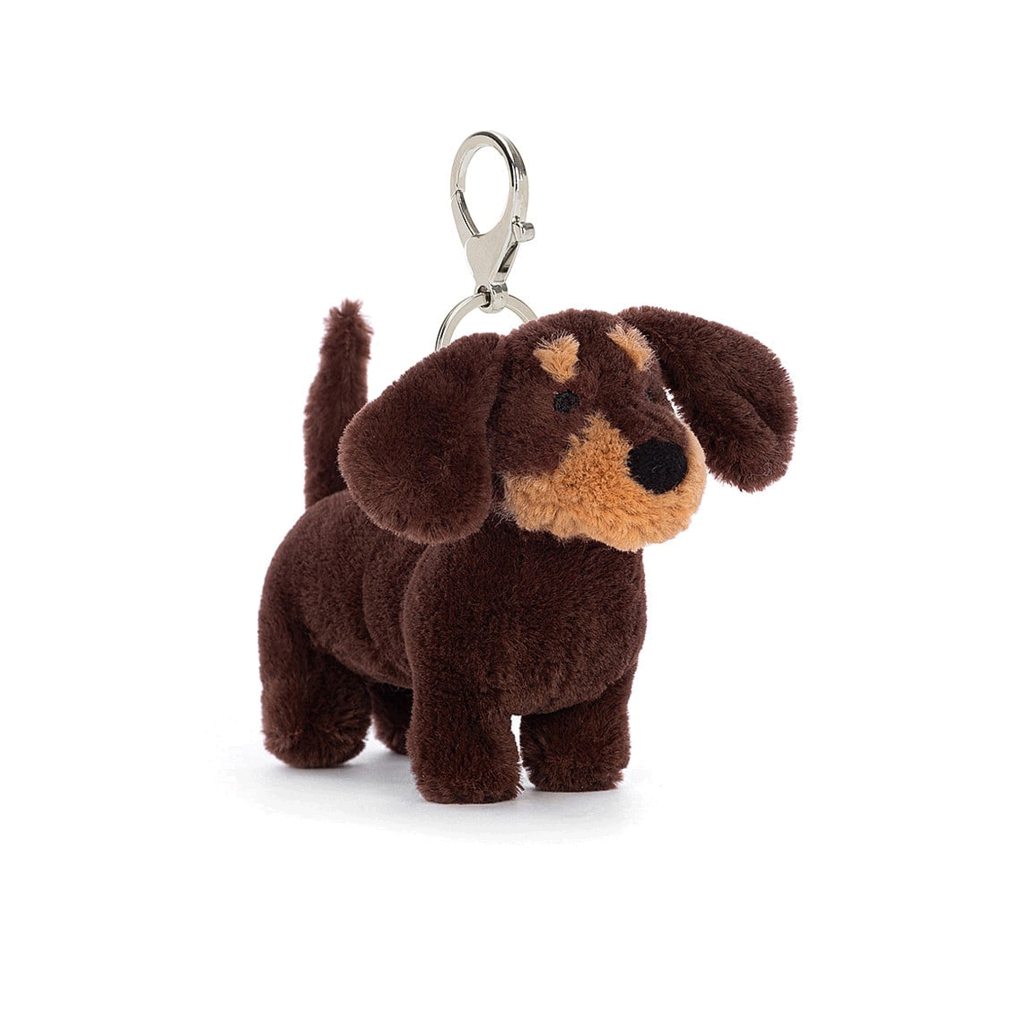 On a white background is a brown dachshund dog stuffed animal on a silver keychain loop.   