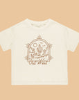 An ivory t-shirt for children with a brown western graphic on the front that reads, "Out West".