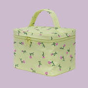 A yellow cosmetic bag with a pink and green flower print.