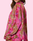 A hot pink and cheetah print button up long sleeve pajama top.