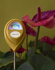 A chartreuse moisture meter with a rounded head and a white meter that ranges from dry, moist, or wet along with a small oval label in the front that reads, "Jungle Club".