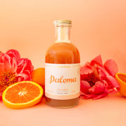 A glass bottle with Paloma cocktail mix.