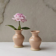 A peach ceramic bud vase. Each vase sold separately.