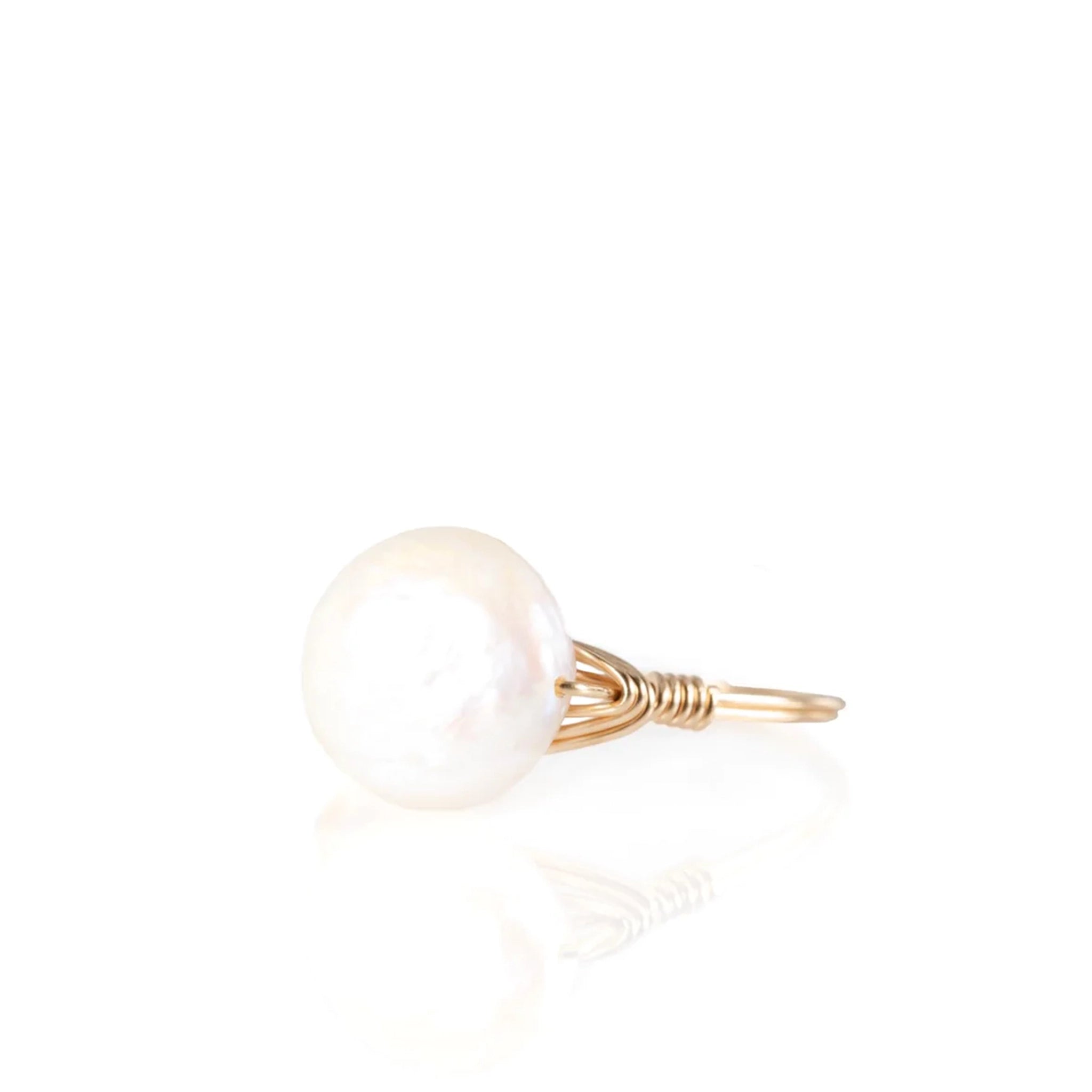 A gold ring, with a circle freshwater pearl in the center.  