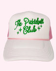 A light pink trucker hat with green embroidered text across the front that reads, "The Pickleball Club".
